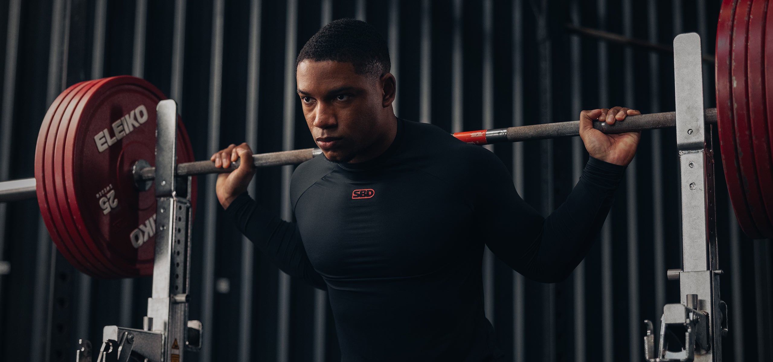 SBD Classic Refresh - athlete in black long sleeve unracking a barbell