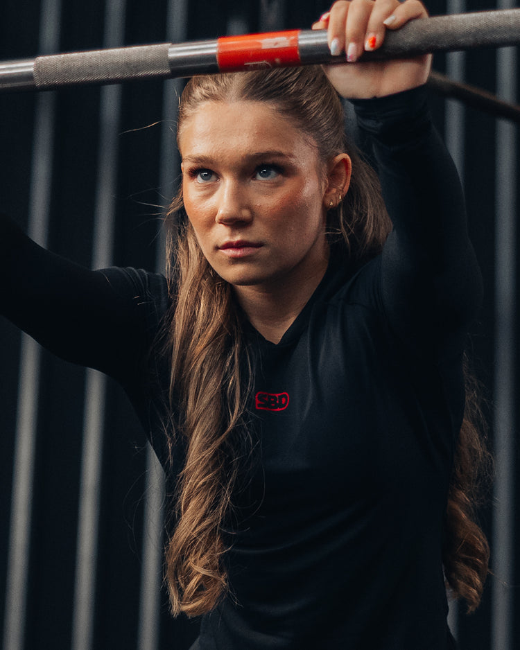 SBD Classic Refresh - athlete in black long sleeve setting up under the bar