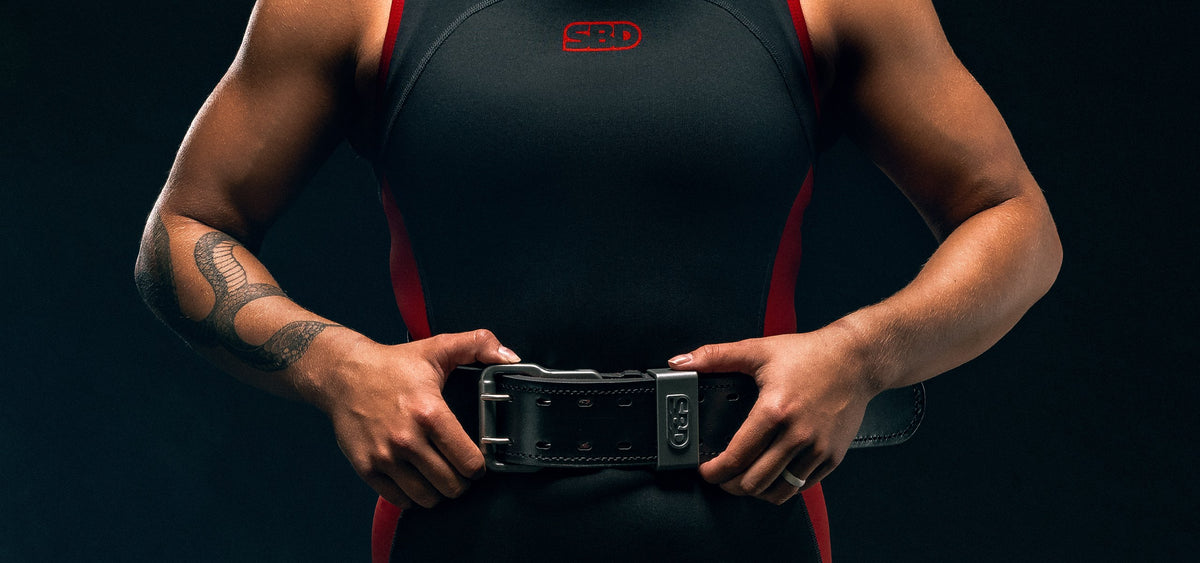 SBD Leather Weightlifting Belt worn by an athlete in a red and black singlet