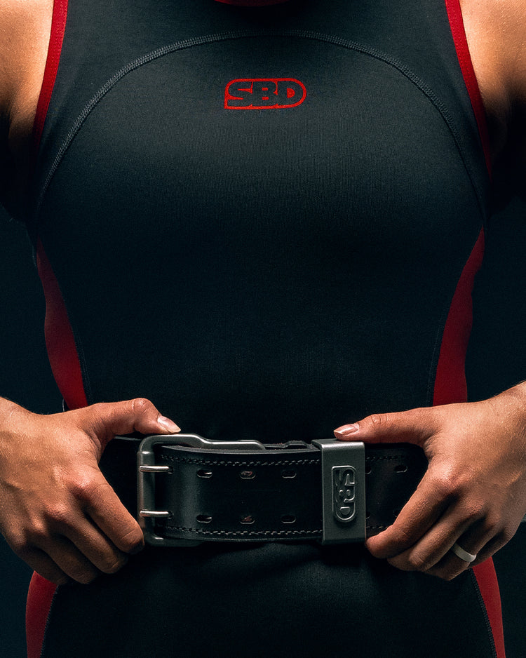 SBD Leather Weightlifting Belt worn by an athlete in a red and black singlet
